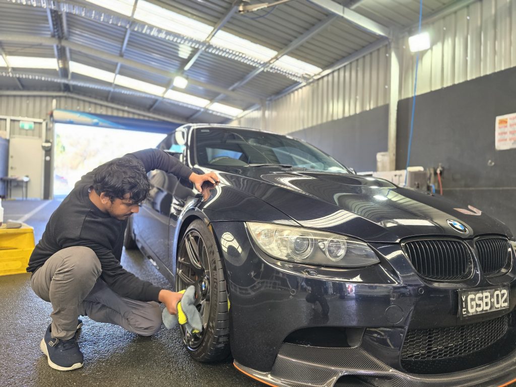 Team member hand washing a BMW